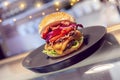 Close-up of home made tasty burgers on plate in restaurant. Royalty Free Stock Photo