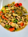 Close up from above from home made winter soup with pasta, beans, peas and carrot Royalty Free Stock Photo