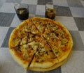 Close-up of a homemade bacon pizza, extra cheese and mushrooms and two glasses of soda Royalty Free Stock Photo