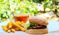 Close up homemade beef burger with mushrooms, micro greens, red onion, beet sauce on wooden board. Royalty Free Stock Photo