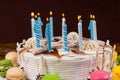 Close up of homemade birthday cake with lots of burning candles