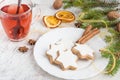 Close up of homemade butter nuts star shaped cookies with icing, pine, orange slices,cinnamon, anise, walnuts and golden ribbon Royalty Free Stock Photo