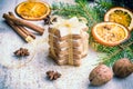 Close up of homemade butter nuts star shaped cookies with icing, pine, orange slices,cinnamon, anise, walnuts and golden ribbon Royalty Free Stock Photo