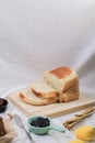 Close up Homemade delicious freshly baked classic sweet banana bread sliced with blueberry/strawberry jam and butter knife on a wh Royalty Free Stock Photo