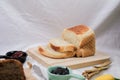 Close up Homemade delicious freshly baked classic sweet banana bread sliced with blueberry/strawberry jam and butter knife on a wh Royalty Free Stock Photo