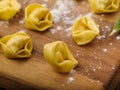 Close-up. Homemade dumplings, ravioli stuffed with minced meat on a wooden cutting board. The process of making homemade ravioli,