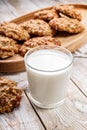Close-up homemade oatmeal cookies and glass milk. Homemade gluten and sugar free recipe. Rustic wooden background and linen napkin Royalty Free Stock Photo