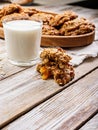 Close-up homemade oatmeal cookies and glass milk. Homemade gluten and sugar free recipe. Rustic wooden background and linen napkin Royalty Free Stock Photo