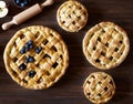 Close up. Homemade pastry apple pie pies bakery on dark wooden kitchen table with raisins, blueberry and apples Royalty Free Stock Photo