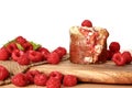 Close up homemade raspberry muffins with raspberries red fruits on wooden board and sack, isolated on white background