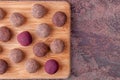 Close Up of Homemade Raw Cacao Energy Balls on Wooden Tray on Marble Background Royalty Free Stock Photo