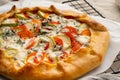 Close up homemade savory galette with vegetables, wheat pie with tomatoes, zucchini, Royalty Free Stock Photo