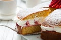 Close up of homemade Victoria sponge cake filled with strawberries, jam and whipped cream