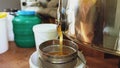 Closeup of honey flowing off harvesting beekeper equipment in apiary Royalty Free Stock Photo