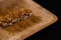 Honey on granola bar in wooden plate Royalty Free Stock Photo