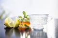 Close up of honey tea isolated on wooden surface i.e. Honey,lemon juice, water, ginger and some mint leaves all mixed together in Royalty Free Stock Photo