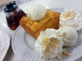 Close up honey toast with vanilla ice cream and whipping cream served on dish