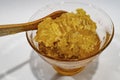 Honeycomb honey in glass bowl with wooden spoon Royalty Free Stock Photo