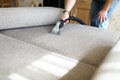 Hoovering sofa with vapor cleaning service at home
