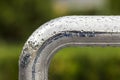 Close-up of horizontal metal wet shiny pipe with big rain water drops on blurred abstract background Royalty Free Stock Photo