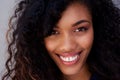 Close up smiling young african american woman against gray wall Royalty Free Stock Photo