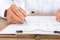 Close-up of hospital doctor checking the list with pen Royalty Free Stock Photo