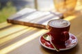 Close up hot art Latte, cappuccino Coffee in red cup on wooden table in Coffee shop blur background with bokeh image Royalty Free Stock Photo