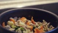 Close up of hot chicken fillet pieces fried in a black pan with vegetables. Concept. Healthy food and diet, delicious Royalty Free Stock Photo