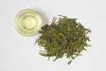 Close-up of hot green tea LongJing in cup. Dragon Well Tea. Top view. Flat lay