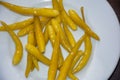 Close up of hot pickled yellow Chili Peppers served on white plate, Royalty Free Stock Photo