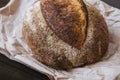 Close-up hot rye circle bread with crispy crust on a craft package Royalty Free Stock Photo