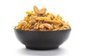 Close-Up of Hot spicy Kashmiri Mixture Namkeen snacks in a black ceramic bowl made with dry fruits, peanuts,.