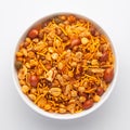 Close-Up of Hot spicy Nav Ratan snacks in a white Ceramic bowl, made with red chili, peanuts. Indian spicy snacks Namkeen, Royalty Free Stock Photo