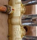 Close up of hot water copper pipe connection onto shower control valve Royalty Free Stock Photo