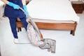 Floor care and cleaning services with vacuume cleaner at hotel room