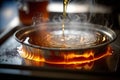 close-up of a hotplate, with the bubbling maple sap being boiled down into syrup