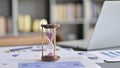 Close Up of Hourglass on Businessman Office Desk Royalty Free Stock Photo