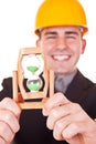 Close-up of hourglass and engineer Royalty Free Stock Photo