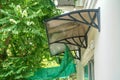 close up house awning and sunshade with star gooseberry tree in home garden