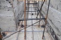 A close-up of a house foundation construction with a wood frame and rebars installed and concrete poured. Building a reinforced Royalty Free Stock Photo