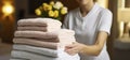 Close up, House keeping lady changing the set of folded and stacked towels in hotel room with freshly made bed. Generative AI