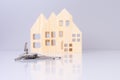 close-up house keys against the background of wooden house models. selective focus. investment, mortgage, real estate