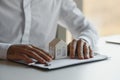 Close up house model with businessman signs a purchase contract or mortgage for a home, buy and sell home model Royalty Free Stock Photo