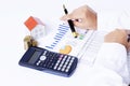 Close up of House paper with coins stack with calculator and han Royalty Free Stock Photo