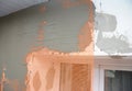 Close up on house plastering wall withfiberglass mesh, plaster mesh after rigid insulation.