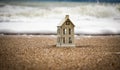 Close - up house in the sand on the beach on the background of sea foam Royalty Free Stock Photo