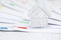 Close up house with step of paperwork with colorful paperclip