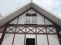 Close up a house with white glass windows and brown wall ornaments