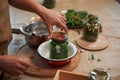 Close-up of a housewife& x27;s hand, putting a sterile lid on a glass jar of freshly pickled organic cucumbers. Pickling. Royalty Free Stock Photo