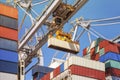 Close-up of how containers are being discharged from a large container ship by a crane Royalty Free Stock Photo